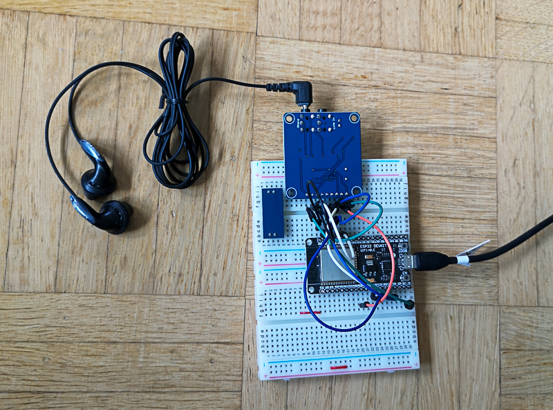 A photograpgh of the breadboard with an ESP32 devkit connected to the VS1003 board and headphones